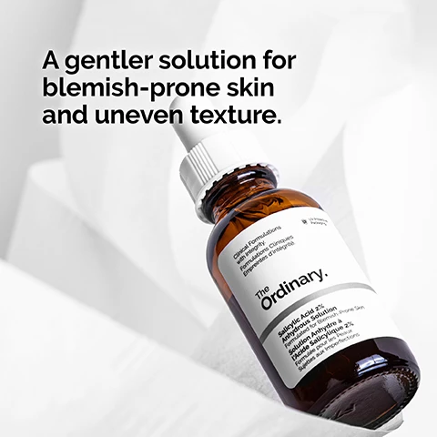 Image 1 - A brown glass bottle of The Ordinary Salicylic Acid 2% Solution is shown on a light background with the text A gentler solution for blemish-prone skin and uneven texture.
              Image 2 - An image featuring clear liquid with bubbles, accompanied by the text 2% salicylic acid targets textural irregularities while removing dead skin cells.
              Image 3 - A close-up of a woman applying a skincare product to her face with a focused expression, alongside the text that reads Apply daily in the evening. Use a small amount for general use.
              Image 4 - A dropper with a clear serum dripping from it above a circular, translucent serum texture, with the text Anhydrous serum texture. visible beneath the image.
              Image 5 - Image shows a series of skincare products organized into three categories: PREP with cleansers and toners, TREAT with water-based serums, eye serums, anhydrous solutions, and oils, and SEAL with suspensions, moisturizers, and SPF.