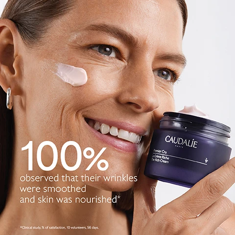 Image 1 - A woman with a smile applies cream to her cheek while holding a jar of Caudalie Premier Cru The Rich Cream, with the text stating 100% observed that their wrinkles were smoothed and skin was nourished.
              Image 2 - A purple background features a jar of Caudalie Premier Cru La Crème Riche with cream spilling out, surrounded by dark grapes, and includes text that reads Natural plumping filler, Improves skin volume, Longevity patent, Stimulates youth proteins, Bio-ceramides, Replenish and protect skin barrier.
              Image 3 - A woman with long brown hair smiles while holding a bunch of dark grapes, with visible text saying Targets all signs of ageing followed by check marks for Wrinkles, Dark spots, and Volume.
              Image 4 - Image shows two jars of CAUDALIE skincare products labeled The Cream and The Rich Cream side by side against a textured background, with features listed for each: The Cream addresses wrinkles, dark spots, volume, suitable for all skin types, with a cream texture; The Rich Cream addresses wrinkles, dark spots, volume, suitable for dry skin, with a rich texture.
              Image 5 - A dark purple background features two jars of Caudalies Premier Cru The Rich Cream, with visible text stating New Premier Cru The Rich Cream, New longevity formula, New natural plumping filler from rosewood.
              Image 6 - A series of four skincare creams displayed on a purple background, labeled from top to bottom as The Serum, The Cream, The Rich Cream, and The Eye Cream.
              Image 7 - A hand holding a jar of cream with a purple lid and a small container of refill cream, accompanied by text instructions on recycling the creams packaging that reads: How to recycle Premier Cru The Rich Cream 1 Keep the glass jar and the cover 2 Recycle the empty refill in the recycling bin 3 Insert a new refill into your jar.