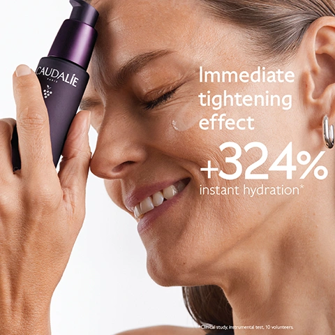 Image 1 - A smiling woman with her eyes closed applies a purple Caudalie Paris serum bottle to her cheek, next to text reading Immediate tightening effect +324% instant hydration* *Clinical study, instrumental test, 10 volunteers. Image 2 - A white, creamy swipe of product with a slight sheen is shown on a purple background, accompanied by text that reads Light texture, Firming effect, and 3,5 times more concentrated in hyaluronic acid for deep hydration. Image 3 - A woman applies a white serum from a purple Caudalie Paris pump bottle to her cheek, with visible text on the image reading Targets all signs of ageing, Wrinkles, Dark spots, Volume. Image 4 - An infographic on a dark purple background showcases three skincare ingredients: a close-up of dark purple berries with water droplets labeled Longevity patent Stimulates youth proteins; a creamy light yellow liquid labeled Natural plumping filler Imrproves skin volume; and a clear yellow liquid with bubbles labeled Niacinamide Smoothes and evens skin tone, with the overall title Ingredients. Image 5 - A chart on a purple background details two Caudalie Premier Cru anti-aging routines, one for all skin types and one for dry skin, each displaying images of a serum bottle, a cream jar, and an eye cream tube with product swatches, with visible text reading Tha anti-ageing routine, All skin types: 1. The Serum, 2. The Cream, 3. The Eye Cream, Dry skin: 1. The Serum, 2. The Rich Cream, 3. The Eye Cream. Image 6 - A close-up of a sunlit bunch of green grapes with text that reads: Powered by the grape. Patented, highly effective, natural formulas. 0% Parabens, phenoxyethanol, mineral oils, PEG, silicones, sodium laureth sulfate, animal ingredients. vegan. 1% FOR THE PLANET. 100% OCEAN PLASTIC COLLECT. Image 7 - A hand holds a dark purple Caudalie Premier Cru Le Sérum The Serum bottle with its pump removed, next to a white box outlining recycling steps: 1 Recycle glass bottle using at-home recycling and 2 Recycle with Terracycle, accompanied by the Terracycle logo with the text TERRACYCLE, all beneath the heading How to recycle Premier Cru The Serum.