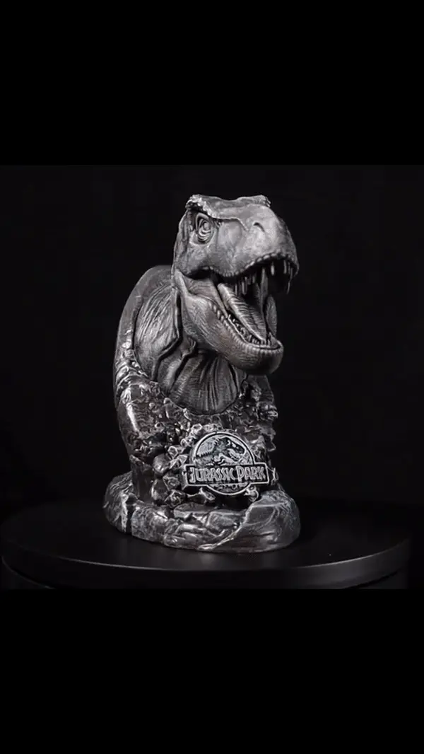 Gif showing a rotating video of the T-Rex statue and the raptor status. Text on the video reads Zavvi exclusive limited edition T-Rex statue. Jurassic park, Fanattik. Zavvi exclusive limited edition Raptor statue. Jurassic World, Fanattik. 
