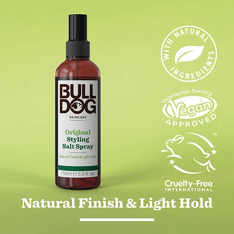 Image 2 - A bottle of Bulldog Skincare Original Styling Salt Spray with a label indicating it contains natural ingredients, is vegan approved, and is cruelty-free, set against a light green background. Visible text includes Bulldog, Original Styling Salt Spray, Natural Finish & Light Hold, and logos for vegan and cruelty-free certifications.
              Image 3 - Close-up image of coarse sea salt on a green background with the text Sea Salt, Sustainably Sourced Mediterranean Sea Salt, Natural Finish & Light Hold.
              Image 4 - A brown spray bottle labeled Bulldog Skincare with a green and white background, featuring the text Original Styling Salt Spray Natural Finish & Light Hold With Sea Salt 150ml e 5.0 fl. oz. and icons indicating Recycled Plastic Bottle and 100% Recycled PCR Bottle.
              Image 5 - A smiling young man with medium brown hair styled upwards and a beard is shown against a neutral background, with the text All Hair Types displayed prominently below him.
              Image 6 - Four hair styling products from Bulldog Skincare are displayed on a light green background, including Original Styling Pomade, Original Styling Cream, Original Styling Salt Spray, and Original Styling Clay, with the text Seriously Good Hair Styling at the bottom.