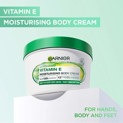 Image 1 - A round container of Garnier Vitamin E Moisturising Body Cream with a green lid, featuring text stating Vitamin E Moisturising Body Cream, Up to 100h hydration, 12% Glycerin + Shea Butter + Vitamin E + Avocado, Dry to very dry skin - fast absorption, and For hands, body and feet.
              Image 2 - A persons hand is holding a jar of Garnier Vitamin E Moisturising Body Cream against a light green background, with text that reads Formulated for extra dry skin, Fast absorption, and Nourishing body cream, along with details about hydration and ingredients.
              Image 3 - A close-up of a smiling person with dark skin applying a lotion to their shoulder, with visible text reading FAST ABSORPTION and STRONGER SKIN BARRIER.
              Image 4 - A tub of Garnier Vitamin E Moisturising Body Cream is shown with a creamy texture in the background, with visible text reading INTENSE MOISTURE BOOST and VITAMIN E MOISTURISING BODY CREAM along with details about hydration and skin types.
              Image 5 - Image of a woman showing her arm before and after applying a product, with visible text stating HYDRATES UP TO 10 CELL LAYERS DEEP* and labeled BEFORE on the left and AFTER on the right.
              Image 6 - An arm with a smooth skin surface rests against a pastel green background, featuring three statements highlighting positive user feedback: 96% would recommend to a friend, 95% say it feels amazing on their skin, and 93% say it didnt leave skin greasy, along with a note about survey participants.