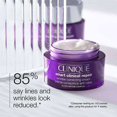 Image 1 - A close-up of a purple jar of Clinique Smart Clinical Repair wrinkle correcting cream, with text stating 85% say lines and wrinkles look reduced and a note about consumer testing on 143 women after using the product for 4 weeks.
              Image 2 - Image showing two close-up sections of skin labeled Before at the top and After at the bottom, with text stating Panelist’s individual results (12 weeks of daily use). Individual results will vary.
              Image 3 - A blurred white background with three words listed vertically: strength, smooth, hydrate, with icons representing strength, smoothness, and hydration.
              Image 4 - A purple background displays a list titled Free of, with check marks indicating the absence of fragrance and oil beneath it.