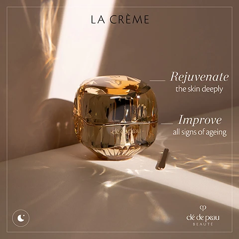 Image 1 - A golden cosmetic jar labeled LA CRÈME sits on a light surface, with rays of light reflecting off its surface, accompanied by text that reads Rejuvenate the skin deeply and Improve all signs of ageing, along with the brand name clé de peau BEAUTÉ.
              Image 2 - A crystal jar of La Crème anti-ageing night cream is centered on a softly lit background, with text stating 100% felt their skin looked smoother and 98% felt their skin looked healthy, along with the brand name Clé de Peau Beauté.