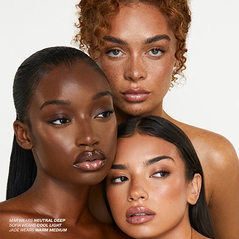 Image 4 - Close-up of three women with diverse skin tones and makeup looks, showcasing different foundation shades with the text Mar wears neutral deep, Sofia wears cool light, Jade wears warm medium. Image 5 - A stack of Iconic London Super Smoother Blurring Skin Tint bottles, in a range of skin tone shades from light to dark, with some bottles open and product dripping out, with visible text reading Lightweight skin tint for 12 hours of satin-matte flawlessly blurred skin. Image 7 - A close-up of a woman with freckles and curly brown hair, her hand resting on her chin, with three text boxes detailing product features: Delivers a smooth, natural base; Soft-focus blurring effect to diffuse the look of pores, and uneven skin tone; Soft-matte, semi-satin, second skin finish that feels weightless.. Image 8 - A flat-top makeup brush with foundation dripping down its bristles and handle is displayed next to instructions titled HOW TO USE, which include: STEP 1 Give the bottle a good shake to mix the formula evenly. STEP 2 Dispense a small amount and use your fingertips, brush, or sponge – your body heat helps melt the product for smoother blending. STEP 3 Apply evenly across your skin for a silky, even base layer of coverage. Image 9 - Four customer reviews for a skin tint are displayed against a background of skin tint swatches; Kelly A writes Love this skin tint, it has just the right amount of coverage to even out my complexion whilst still looking like glowy skin! A little bit goes a long way, gives such a natural smooth finish; Jessica writes Perfect amount of coverage. Not too cakey as Ive found with other foundations. Colour matching it pretty spot on as well - Would recommend!; Shayna writes AMAZING. Its so perfect. Gets rid of my redness, doesnt stick to any dry spots, doesnt make me oily, not thick but not too thin. The no makeup makeup look is brought to life with this!; and Flora writes This is a gorgeous tint, such a perfect color for my very fair skin. It melts on and stays on all day, especially when paired with the Iconic London primer skin tint. Love it.