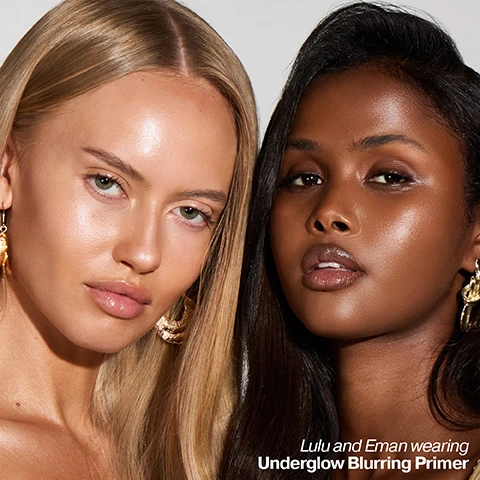 Image 2 - A close-up of two women, one with blonde hair and fair skin and the other with dark hair and dark skin, both looking at the camera with radiant, glowing complexions, with text that reads Lulu and Eman wearing Underglow Blurring Primer. Image 3 - A close-up of shimmery peachy-beige cosmetic liquid swatched with visible streaks and sparkle, with the text Underglow Blurring Primer Primes, preps, minimises the appearance of pores. Image 4 - A close-up of a peachy-toned product bottle with a dropper dispensing a shimmery liquid, featuring the text ICONIC LONDON, UNDERGLOW BLURRING PRIMER, Vitamin C This antioxidant helps fight free radicals to prevent aging and boost radiance. Artemisia Capillaris Japanese plant extract helps to protect against Blue HEV Light. Soft Focus Blurring Powders Gives a soft touch and blurs light to reduce the look of fine lines. Image 5 - A close-up of a person with dark skin applying a light-colored liquid product to their cheekbone with a finger, alongside text that reads how to use Shake the bottle well and apply 2-3 drops all over the face, focusing on any areas that are often prone to excess shine. Image 6 - The image shows drops and smears of a peach-colored liquid on a white background, with five text overlays that read: help your makeup last longer; even skin tone and blur imperfections; skin feels instantly hydrated; doesn’t block pores or feel greasy or sticky; Use alone for an effortless no-makeup makeup look. Image 7 - A split image of a womans face, with the left side showing skin with visible pores and a matte finish, and the right side showing skin with a blurred, glowing finish, with text that reads Velvet Smooth Pore-Refining Primer on the left and Underglow Blurring Primer on the right. Image 8 - A close-up of a persons face with fair, glowing skin, featuring three customer reviews with five stars each: Love this underglow primer, gives perfect smooth base - Kelly; My favourite primer it is the best feels amazing on the skin on no makeup days still like to have this on for a little glow - Laura; Absolutely in love with this primer so easy to apply and skin feels so clear and soft - Anne.