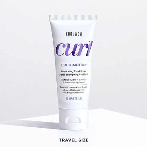Image 6 - A travel-size tube of Curl Wow Coco-Motion Lubricating Conditioner with a white background, featuring purple text and text in both English and French detailing the products benefits and usage.