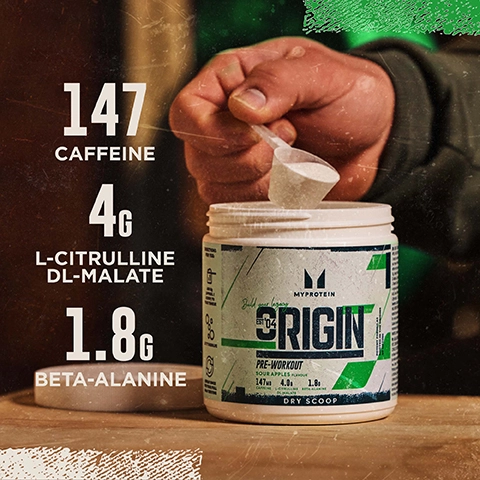 A hand is scooping powder from a white container labeled MyProtein with visible text listing nutritional information: 147 caffeine, 4g L-citrulline DL-malate, and 1.8g beta-alanine.