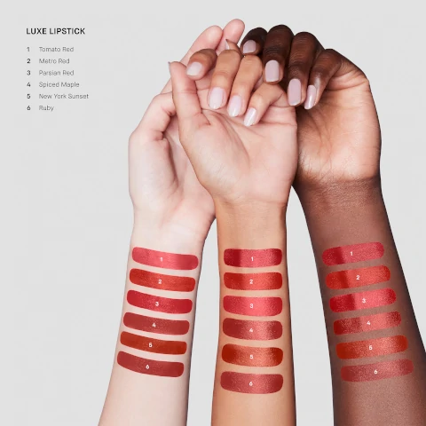 Model arm swatch of all shades including: Tomato red, metro red, parsian red, spiced maple, new york sunset and ruby