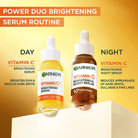 Image 1 - The image displays two Garnier Vitamin C dropper bottles, one containing a yellow brightening serum for day and the other a brown brightening night serum, with text that reads: POWER DUO BRIGHTENING SERUM ROUTINE DAY VITAMIN C BRIGHTENING SERUM BRIGHTEN SKIN & REDUCE DARK SPOTS GARNIER VITAMIN C BRIGHTENING SERUM 4% VITAMIN C*, NIACINAMIDE + SALICYLIC ACID + MELASYL NIGHT VITAMIN C BRIGHTENING NIGHT SERUM REDUCES APPEARANCE OF DARK SPOTS, DULLNESS & FINE LINES GARNIER VITAMIN C BRIGHTENING NIGHT SERUM 10% PURE VITAMIN C. Image 10 - Two women, one with short blonde hair and one with dark hair, pose holding two different Garnier Vitamin C serum bottles with droppers, with text reading BRIGHTENING POWER DUO SERUMS and DOUBLE THE VITAMIN C POWER. Image 2 - A woman applies serum to her face with two droppers, set against a yellow background with a decorative clock showing day and night, and the overlaid text FIGHTS THE APPEARANCE OF DARK SPOTS DAY & NIGHT. Image 3 - A woman with smooth, glowing skin gently touches her cheek against a blue sky background, with text that reads Our highest Vitamin C concentration and Skin looks smoother, suppler, revitalised & rested. Image 4 - A Garnier Vitamin C+ Brightening Serum bottle is displayed on a white block against a yellow and orange background, alongside text that reads THE UK’S N°1 VITAMIN C SERUM* JUST GOT BETTER** & BRIGHTER and a box stating PROVEN EFFICACY*** DARK SPOTS VISIBLY REDUCED: 97% AGREE INSTANTLY BRIGHTENS SKIN: 74% AGREE IMPROVED SKIN EVENNESS: 98% AGREE, with additional small disclaimer text. Image 5 - A woman with dark hair gently touches her cheek near her eye, looking towards the camera against a clear blue sky, with the text PROVEN EFFICACY, SKIN LOOKS SMOOTHER & REVITALISED, SKIN LOOKS BRIGHTER & HEALTHIER, APPEARANCE OF FINE LINES & DARK SPOTS ARE REDUCED. Image 6 - A woman with glowing skin touches her face, with overlay text 99% AGREE SKIN IS GLOWING* and REDUCES DARK SPOTS above a before and after skin comparison showing reduced dark spots, labeled BEFORE and AFTER**, followed by small print *Self assessment, 111 women. **Individual results (8 weeks daily use). Individual results will vary. Image 7 - A Garnier Vitamin C Brightening Night Serum bottle with a dropper is shown on a white block against a yellow-orange background, next to a chart displaying efficacy results, with text that reads REVITALISE YOUR SKIN EVERY NIGHT WITH VITAMIN C BRIGHTENING NIGHT SERUM, GARNIER, VITAMIN C BRIGHTENING NIGHT SERUM, 10% PURE VITAMIN C, PROVEN EFFICACY*, SKIN LOOKS SMOOTHER 89% AGREE, SKIN LOOKS REVITALISED 82% AGREE, SKIN APPEARS BRIGHTER 84% AGREE, *SELF-ASSESSMENT, 79 SUBJECTS. Image 8 - A dropper dispenses golden serum into an open Garnier Vitamin C Brightening Night Serum bottle, with text displaying NIGHT ROUTINE, STEP 1 APPLY 3-4 DROPS ON CLEANSED FACE & NECK, and STEP 2 APPLY YOUR MOISTURISER FOR A PERFECT SKIN FINISH. Image 9 - A close-up of a persons face with a hand holding a dropper dispensing a drop of liquid onto their cheek, with overlay text that reads HOW TO USE?, USE 1 FULL PIPETTE, APPLY ON CLEAN SKIN, and MASSAGE GENTLY.