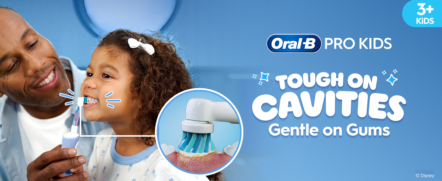 Smiling child brushing teeth with the help of an adult using an Oral-B Frozen toothbrush. Highlight on the round brush head. Text: “Tough on Cavities, Gentle on Gums.”