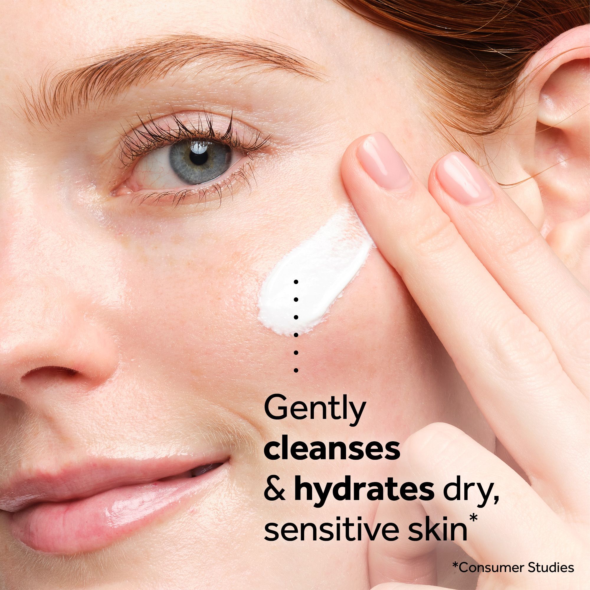 A close-up shows a womans face as she applies cream with her finger with the text Gently cleanses & hydrates dry, sensitive skin* *Consumer Studies.