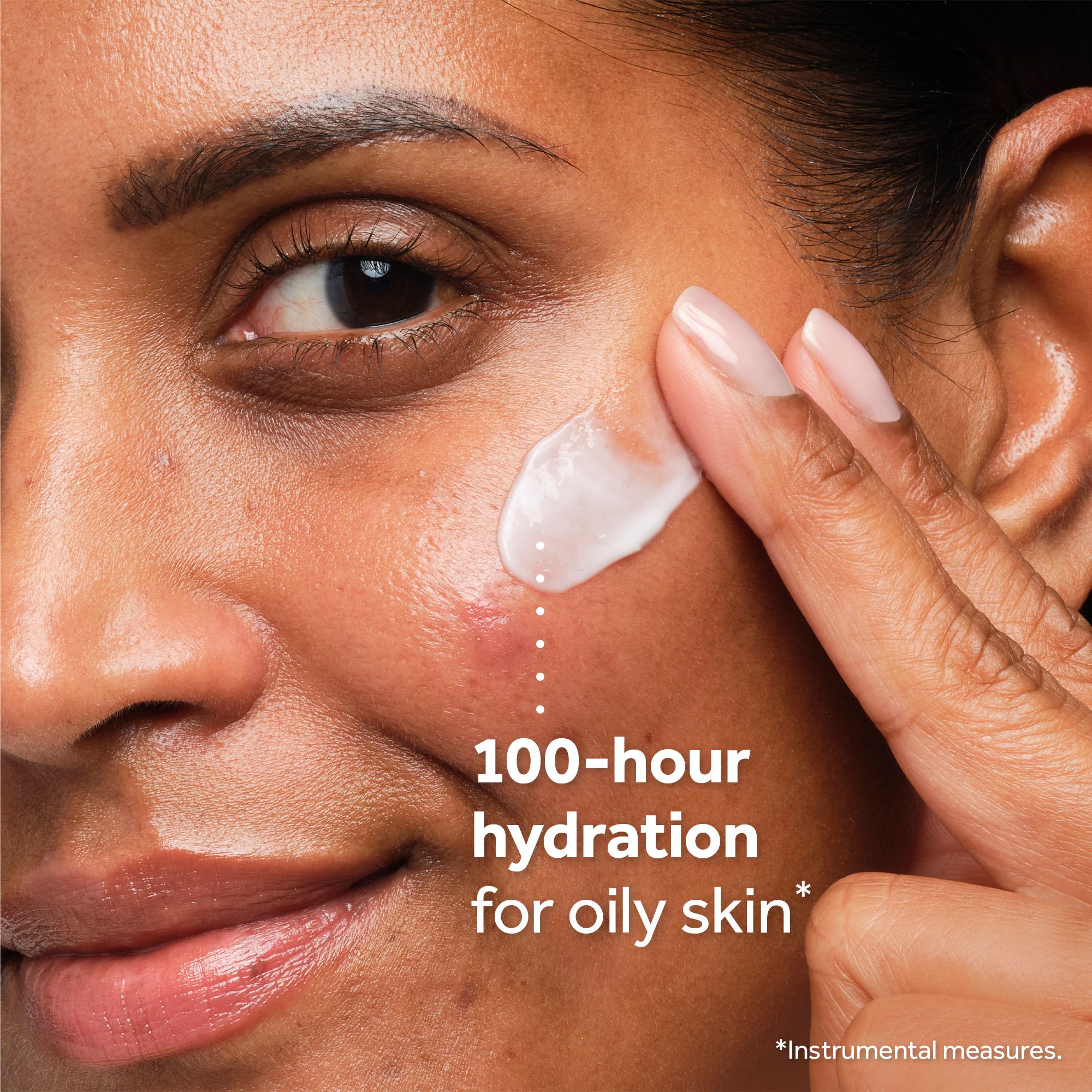 Close-up of a person applying cream to their cheek next to the text 100-hour hydration for oily skin * *Instrumental measures.