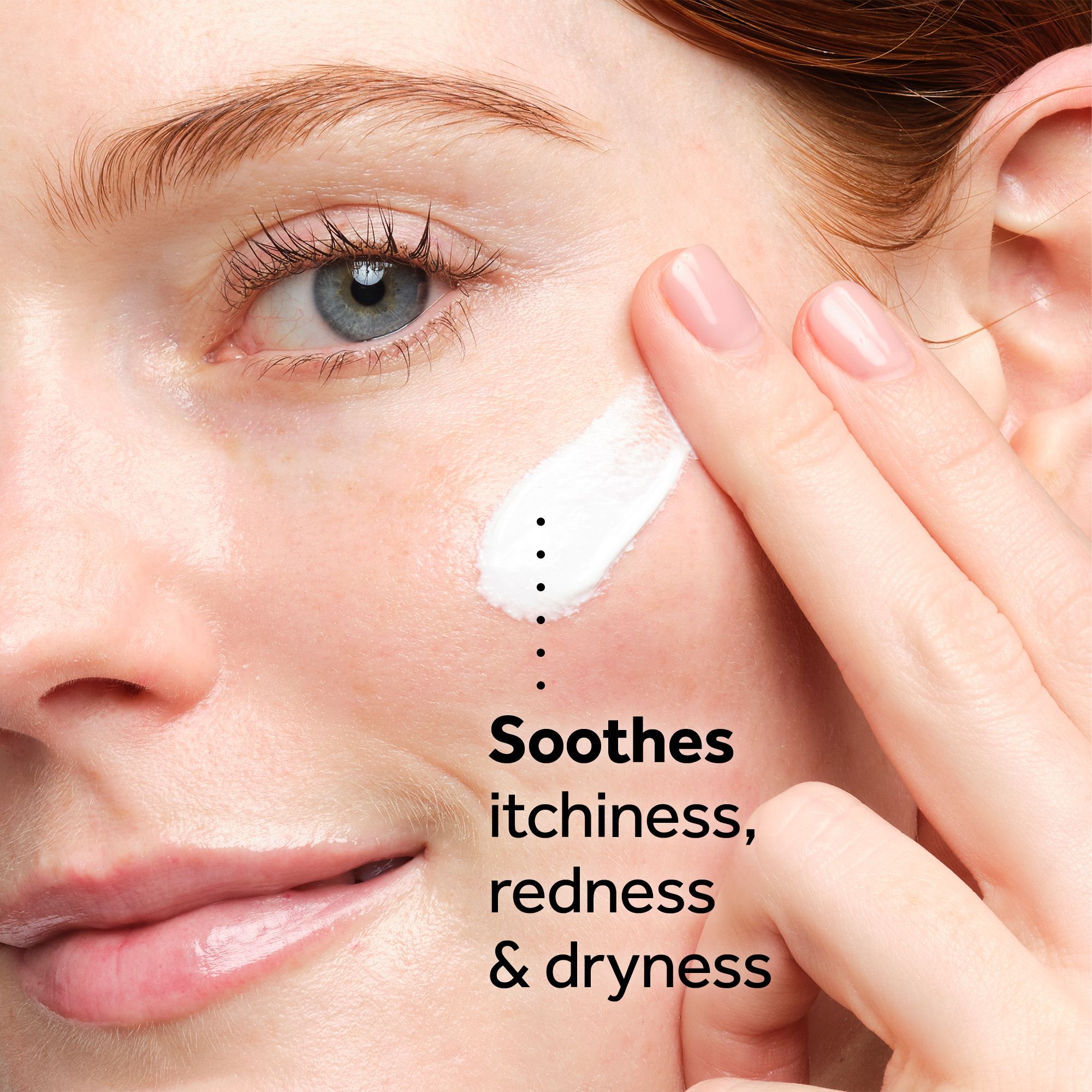 A persons hand applies white cream to their cheek next to the text Soothes itchiness, redness & dryness.