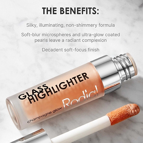 A glass bottle of Rodial Glass Highlighter with a clear cap shows a soft beige liquid, displayed next to a foam applicator, with text that reads THE BENEFITS: Silky, illuminating, non-shimmery formula Soft-blur microspheres and ultra-glow coated pearls leave a radiant complexion Decadent soft-focus finish.