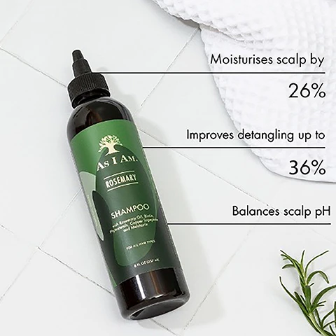 Image 1 - A bottle of As I Am Rosemary Shampoo is placed on a white tiled surface with visible text highlighting benefits: moisturises scalp by 26%, improves detangling up to 36%, and balances scalp pH.
              Image 2 - A bottle of As I Am Rosemary shampoo is displayed on light green steps, accompanied by symbols and text indicating it is vegan and cruelty-free, sulfate-free, and has a natural fragrance.