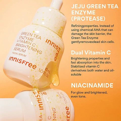 Image 4 - Two Innisfree serum bottles, one tilted and dripping yellowish serum with particles, display the text Innisfree Green Tea Enzyme Vitamin C Brightening Serum Facial Serum 30 mL 1.0 FL.OZ., alongside a description of ingredients: JEJU GREEN TEA ENZYME (PROTEASE) Refining properties. Instead of using chemical AHA that can damage the skin barrier, the Green Tea Enzyme gently removes dead skin cells. Dual Vitamin C Brightening properties and fast absorption into the skin. Stabilized vitamin C derivatives both water and oil-soluble. NIACINAMIDE For glow and brightened, even tone. Image 5 - A womans face is split vertically, showing the left side with natural skin labeled BEFORE Bare Face, and the right side with visibly brighter, luminous skin labeled INSTANTLY AFTER Visibly Brighter Complexion. Image 6 - A white Innisfree serum dropper bottle is partially embedded in a pink grapefruit, with visible text on the image including Innisfree YOUR DAILY SHOT OF VITA C, 93% felt that their pores are cleaned up after using the product*, 83% felt that dull, dead skin looks cleaned using the product*, 83% felt that their skin is less oily using the product*, *Based on a 14-day independent consumer study on 30 women aged 20-35, and on the bottle itself: innisfree GREEN TEA ENZYME VITAMIN C BRIGHTENING SERUM FACIAL SERUM innisfree 30mL 1.01FL. OZ. Image 7 - A hand holds an open white bottle of Innisfree brightening serum with a dropper dispensing a yellow liquid, with text on the image reading KOREAN BRIGHTENING SERUM, Green Tea Extract to help soothe and brighten, Wont clog pores + Safe for acne prone skin, Liquid gel texture melts into skin, Dermatologically tested, and on the bottle itself Innisfree Green Tea Enzyme Vitamin C Brightening Serum Facial Serum 30 mL 1.01 FL. OZ. Image 8 - A person with fair skin and freckles applies serum to their cheek with a dropper, holding a bottle of Innisfree Green Tea Enzyme Vitamin C Brightening Serum, with overlaid text that reads WHO IS THIS GOOD FOR? followed by three points: Dark Spots + Sun Spots, Uneven texture, Dullness.