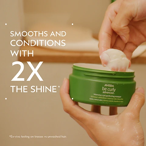Image 2 - A persons hands hold an open green jar of AVEDA be curly advanced intensive curl perfecting masque, with a dollop of white cream being scooped out, next to text that reads SMOOTHS AND CONDITIONS WITH 2X THE SHINE* and *Ex-vivo testing on tresses vs unwashed hair. Image 3 - A before and after image showing the back of a persons head with reddish-brown, wavy hair; the left side, labeled BEFORE, shows hair with less defined curls and some frizz, while the right side, labeled AFTER, shows more hydrated and defined curls, with additional text Unwashed Hair and Results with Be Curley Advanced™ Shampoo, Intensive Curl Perfecting Masque, Curl Perfecting Primer, and Curl Enhancing Cream. Blow dried with diffuser and finished with Control Paste™. Image 4 - A dark green graphic featuring a circular inset of three dark purple kokum fruits with green leaves on a white background, with text that reads Kokum Seed Butter and Deeply nourishes, conditions, detangles. Image 5 - A split image shows a woman with reddish-brown hair, labeled BEFORE on the left with slightly wavy hair and the text Unwashed Hair, and labeled AFTER on the right with more defined, voluminous curls and the text Results with Be Curly Advanced™ Shampoo, Intensive Curl Perfecting Masque, Curl Perfecting Primer, and Curl Enhancing Cream. Blow dried with diffuser and finished with Control Paste™. Image 6 - A dark green infographic titled How to Use displays three steps for Aveda Be Curly Advanced products: 01 Cleanse Be Curly Advanced™ Shampoo, shown with wet hair; 02 Condition Be Curly Advanced™ Intensive Curl Perfecting Masque, shown with a hand scooping cream from a jar; and 03 Style Be Curly Advanced™ Curl Perfecting Primer and Curl Enhancer Cream Control Paste™, shown with a tube, spray bottle, and jar. Image 8 - The image shows three white certification logos against a background of green plant leaves: a 100% Vegan V logo, a Certified B Corporation logo, and a Cruelty Free International Leaping Bunny logo.