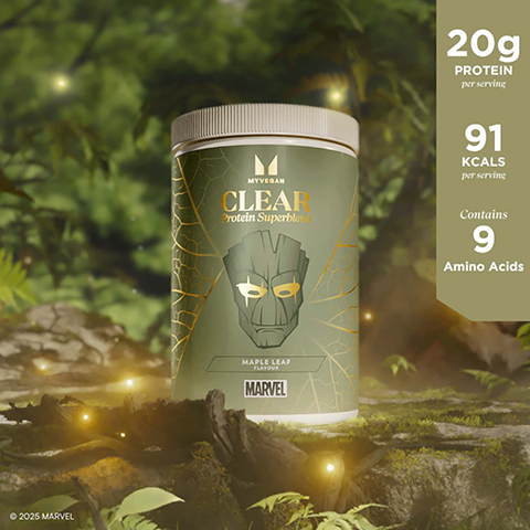 A light green MyVegan Clear Protein Superblend container, adorned with gold leaf patterns and a stylized face, rests in a lush forest setting with glowing orbs; the visible text states MYVEGAN, CLEAR Protein Superblend, MAPLE LEAF FLAVOUR, MARVEL, 20g Protein per serving, 91 KCALS per serving, Contains 9 Amino Acids, and © 2025 MARVEL.