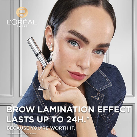 Image 1 - A close-up portrait of a woman with bold eyebrows holding a cosmetic product, wearing a denim jacket and silver earrings, against a light gray background with the text BROW LAMINATION EFFECT LASTS UP TO 24H.* BECAUSE YOURE WORTH IT. visible in white lettering.
              Image 2 - A silver tube of brow lamination product with a brush applicator partially pulled out, set against a light grey background, featuring the text NO RESIDUE, DOES NOT TRANSFER, ALL DAY WEAR, EASY TO REMOVE along with LOREAL PARIS and UP TO 24H.
              Image 3 - A close-up of a woman holding a brow product in front of her face, demonstrating lifted eyebrows, with another woman smiling in the background, featuring the text GET LIFTED & FULLER LOOKING BROWS THAT HOLDS FOR UP TO 24H.
              Image 4 - The image shows a side-by-side comparison of a persons eyes, with the left labeled BEFORE showcasing lightly filled brows and the right labeled AFTER demonstrating fuller, styled brows.
              Image 5 - A close-up image of an angled eyebrow brush against a plain gray background, with visible text stating our precise angled brush to get a lifted and fuller brow look.