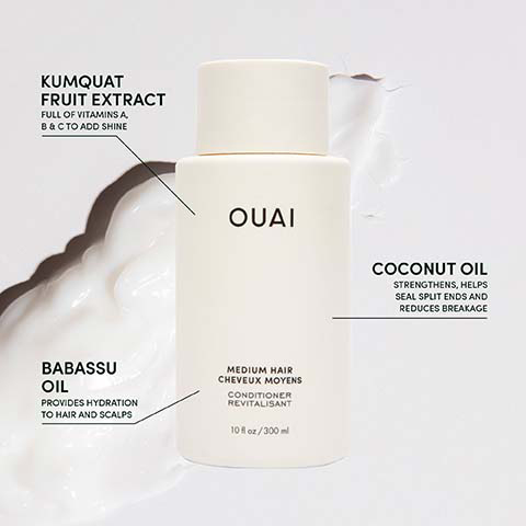A white OUAI conditioner bottle is surrounded by a creamy white product, with descriptive text linked by lines: Kumquat Fruit Extract full of vitamins A, B & C to add shine, Babassu Oil provides hydration to hair and scalps, and Coconut Oil strengthens, helps seal split ends and reduces breakage; the bottle itself is labeled OUAI, Medium Hair Cheveux Moyens, Conditioner Revitalisant, 10 fl oz / 300 ml.