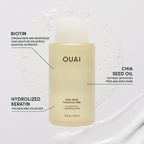 A bottle of OUAI shampoo for fine hair is shown with highlights of key ingredients: Biotin, which strengthens hair health, Chia Seed Oil, which softens and adds shine, and Hydrolyzed Keratin, which thickens and volumizes, alongside visible text describing the product size of 10 fl oz or 300 ml.