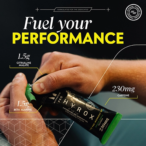 A person is holding a black workout gel bottle labeled HYROX with green accents; the image includes text stating Fuel your PERFORMANCE, 1.5g CITRULLINE MALATE, 1.5g BETA ALANINE, and 230mg CAFFEINE.