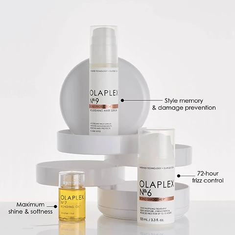Image 3 - Three Olaplex hair products are displayed on white tiered stands: Olaplex Nº9 Bond Protector Nourishing Hair Serum, described on its label as a Hydrating rich serum that improves manageability, moisture and protects from daily dam, with a callout indicating Style memory & damage prevention; Olaplex Nº6 Bond Smoother, described on its label as a Leave-in styling treatment that adds moisture, strengthens & reduces frizz for up to 72 hours in a 100 mL / 3.3 fl. oz bottle, with a callout indicating 72-hour frizz control; and Olaplex Nº7 Bonding Oil in a 30 mL / 1 fl. oz bottle, with a callout indicating Maximum shine & softness. Image 4 - A person with tan-painted nails holds a white Olaplex No. 6 Bond Smoother bottle in one hand, while a small dollop of white cream rests on a finger of the other hand, with overlay text 72 Hr FRIZZ CONTROL AND HUMIDITY RESISTANCE and text on the bottle PATENTED TECHNOLOGY OLAPLEX OLAPLEX No. 6 BOND SMOOTHER LEAVE-IN STYLING TREATMENT ADDS MOISTURE, STRENGTHENS & REDUCES FRIZZ FOR UP TO 72 HOURS 100 mL / 3.3 fl. oz. Image 5 - A split image shows a before and after comparison of dark brown curly hair, with the left side labeled BEFORE depicting frizzy, less defined curls and the right side labeled AFTER depicting smoother, more defined curls, accompanied by the text UNRETOUCHED IMAGES* *Results may vary. Results achieved by cleansing with N°4 Bond Maintenance® Shampoo, conditioning with N°5 Bond Maintenance® Conditioner, and applying N°6 Bond Smoother® to damp hair before styling. Image 6 - A white pump bottle of Olaplex Nº6 Bond Smoother is shown next to a small yellow bottle of Olaplex Nº7 Bonding Oil, with visible text reading Add OLAPLEX N°7 for Frizz Control and Shine; the Nº6 product is described with Smooth Frizz + Hydrate and its label states OLAPLEX N°6 BOND SMOOTHER PATENTED TECHNOLOGY • OLAPLEX.COM LEAVE-IN STYLING TREATMENT ADDS MOISTURE, STRENGTHENS & REDUCES FRIZZ FOR UP TO 72 HOURS 100 mL / 3.3 fl. oz.; and the Nº7 product is described with Boost Shine + Softness and its label states OLAPLEX N°7 BONDING OIL 30 mL / 1.0 fl. oz. Image 7 - A white Olaplex No. 6 Bond Smoother pump bottle stands on a creamy white swirled background, with accompanying text reading 72-HR FRIZZ CONTROL, SMOOTHS ANY STYLE, SOFTENS AND HYDRATES, HUMIDITY-RESISTANT FORMULA, and text on the bottle reading PATENTED TECHNOLOGY OLAPLEX.COM OLAPLEX N°6 BOND SMOOTHER LEAVE-IN STYLING TREATMENT ADDS MOISTURE, STRENGTHENS & REDUCES FRIZZ FOR UP TO 72 HOURS 100 mL / 3.3 fl. oz. Image 8 - The image features several white Olaplex N°6 Bond Smoother product bottles, with visible instructions APPLY to clean, damp hair, COMB through, STYLE as desired, and Start with 1 pump. Add more as needed, while the labels on the bottles read OLAPLEX N°6 BOND SMOOTHER, LEAVE-IN STYLING TREATMENT ADDS MOISTURE, STRENGTHENS & REDUCES FRIZZ FOR UP TO 72 HOURS, 100 mL / 3.3 fl. oz., PATENTED TECHNOLOGY + OLAPLEX.COM. Image 9 - The image features a small yellow bottle of Olaplex N°7 Bonding Oil and a white pump bottle of Olaplex N°6 Bond Smoother, surrounded by oil drops and a streak of cream, with overlaid text reading PRO TIP Want to boost shine, strength, and frizz control? Layer or mix with OLAPLEX N°7 Bonding Oil™, and further label text on the N°7 bottle OLAPLEX N°7 BONDING OIL 30 mL / Net 1 fl oz, and on the N°6 bottle PATENTED TECHNOLOGY OLAPLEX.com OLAPLEX N°6 BOND SMOOTHER™ LEAVE-IN STYLING TREATMENT ADDS MOISTURE, STRENGTHENS & REDUCES FRIZZ FOR UP TO 72 HOURS 100 mL / 3.3 fl. oz.