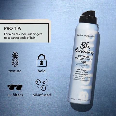 Image 1 - A light blue can of Bumble and bumble Dryspun Texture Spray is displayed on a metallic background with icons indicating texture, hold, UV filters, and oil-infused properties, alongside a pro tip that reads for a piecey look, use fingers to separate ends of hair.
              Image 2 - A woman with curly hair is shown in two side-by-side images; the left image depicts her hair in a more natural state labeled as BEFORE, and the right image shows her with enhanced volume and defined curls labeled as AFTER with the text Thickening Dryspun Texture Spray Light above it.