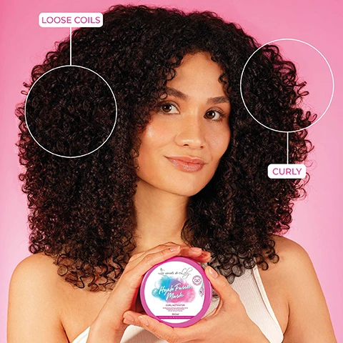 Image 1 - A woman with large, voluminous curly hair smiles while holding a pink jar labeled Hazel Texture Mask Curl Activator in front of a pink background, with text on the image identifying sections of her hair as Loose Coils and Curly.
              Image 2 - Image shows a pink background with a hair care product jar labeled Hyalur Fusion Mask at the center, with the text A REAL CURL ACTIVATOR above it and 87% BOUNCIER CURLS below.
              Image 3 - A hand is holding a round container of Hyda Fusion Mask with a gradient color design, against a pink background, and includes text arrows pointing to features described as hydrates in depth, activates curl bounce, and even curls.
              Image 4 - A pink and white jar labeled Hyla Fusion Mask sits on a reflective surface surrounded by purple flowers, with highlighted text describing ingredients: Marshmallow Extract smoothes the fiber and adds slip, Hyaluronic Acid rehydrates in depth, and Chickpea Extract proteins and amino acids rich for a bouncy effect.