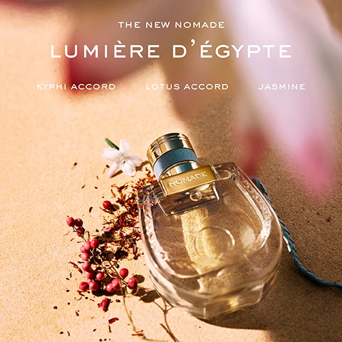 Image 1 - A perfume bottle labeled NOMADE is displayed on sand, surrounded by scattered petals and berries, with text reading THE NEW NOMADE, LUMIÈRE DÉGYPTE, KYPHI ACCORD, LOTUS ACCORD, and JASMINE.
              Image 2 - Image shows three bottles of Chloés Nomade fragrances, each with distinct backgrounds and labels: the left bottle labeled Nomade Eau de Parfum, the center bottle labeled Nomade Nuit dÉgypte, and the right bottle labeled Nomade Lumière dÉgypte, accompanied by descriptions of floral, amber, and solar scents respectively, with the brand name Chloé prominently featured at the bottom.
              Image 3 - Two perfume bottles are displayed on a sandy surface, with a blue decorative plate beside them; visible text includes NOMADE LUMIÈRE DÉGYPTE A SOLAR BLUE LOTUS ACCORD and NOMADE NUIT DÉGYPTE AN AMBERY ORANGE-BLOSSOM.