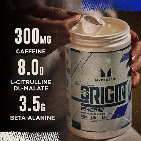 Image 2 - A persons hand scoops light-colored powder from a white Myprotein Origin Pre-Workout tub, which advertises Build your legacy EST 04 and Blue Raspberry Fizz Flavour, and lists ingredients as 300MG CAFFEINE, 8.0G L-CITRULLINE DL-MALATE, 3.5G BETA-ALANINE.