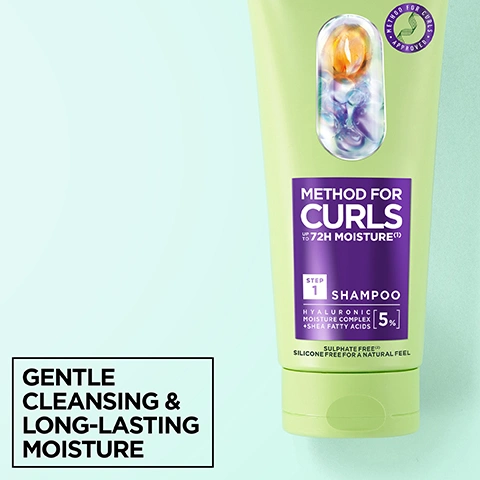 Image 1 - A light green shampoo bottle with a purple label and a clear capsule showing orange and purple liquid inside, stands on a light blue and green background, with text on the bottle reading METHOD FOR CURLS APPROVED, METHOD FOR CURLS UP TO 72H MOISTURE(1), STEP 1 SHAMPOO, HYALURONIC MOISTURE COMPLEX + SHEA FATTY ACIDS [5%], SULPHATE FREE(2), SILICONE FREE FOR A NATURAL FEEL, and additional text in a black box reading GENTLE CLEANSING & LONG-LASTING MOISTURE. Image 2 - A smiling woman with voluminous blonde curly hair looks at the camera against a light teal background, with white text overlaying the image that reads CURLS FEEL MOISTURISED FOR UP TO 72H* and smaller text that reads *Instrumental test, after use of shampoo and mask. Image 3 - A close-up of a white, foamy liquid with bubbles includes the text NO silicones for a natural feel, NO sulphates*, NO alcohol**, NO artificial colourants, *Sulphate surfactant, **No ethylic alcohol. Image 4 - A light green Garnier Method for Curls shampoo bottle with a clear window showing orange and blue beads is displayed alongside two black and white badges; the bottle features text including Garnier, Method for Curls Approved logo, Method For Curls up to 72H Moisture(1), Step 1 Shampoo, Hyaluronic Moisture Complex + Shea Fatty Acids 5%, Sulphate Free(2), Silicone Free For A Natural Feel, while the badges read Cruelty Free International TM with a bunny logo and VEGAN FORMULA* *No animal-derived ingredients or by-products. Image 5 - The image shows three close-up sections of curly hair in blonde, dark brown, and reddish-brown colors, with overlay text that reads: DESIGNED FOR ALL CURL TYPES, INCLUDING TYPE 4 CURLS AND COILS. Image 6 - A hand squeezes a green Garnier Method for Curls 1 Shampoo bottle, which is Sulphate Free and Silicone Free for a Natural Feel with Hyaluronic Moisture Complex + Shea Fatty Acids [5%], dispensing white product into another hand, while text on the right reads: STEP 1 HYDRATING SHAMPOO, UP TO 72 HOURS OF SMOOTHNESS*, CURLS FEEL MOISTURISED & ARE GENTLY CLEANSED, *Instrumental test after use of shampoo and mask. Image 7 - The image features a clear capsule filled with green liquid, colorful bubbles, and particles on a light green background, with text that reads 5% HYALURONIC ACID + SHEA BUTTER LOCKS IN MOISTURE, HYDRATES HAIR & SEALS DAMAGED CUTICLES. Image 8 - A light green Garnier Method for Curls shampoo tube is displayed, featuring text that reads NO SILICONES FOR A NATURAL FEEL, NO SULPHATES*, NO ARTIFICIAL COLOURANTS, Garnier, Method For Curls Approved, Method For Curls Up To 72H Moisture (1), 1 Shampoo, Hyaluronic Moisture Complex + Shea Fatty Acids [5%], Sulphate Free (2) Silicone Free For A Natural Feel, and *Sulphate Surfactant.