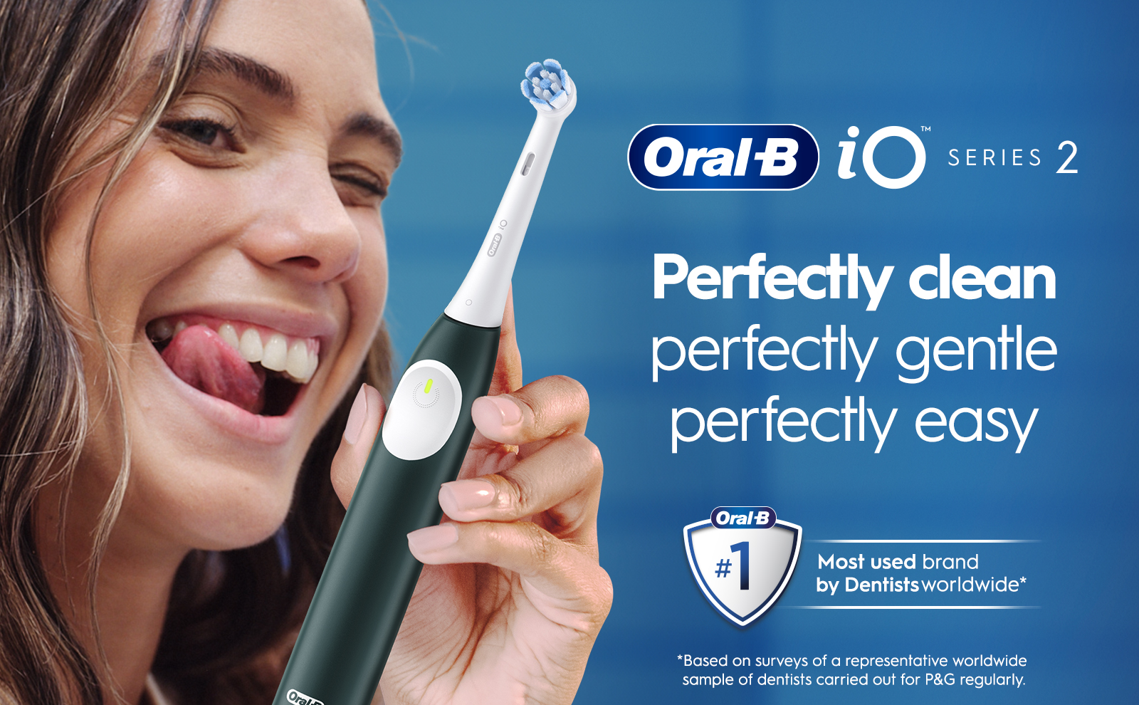 Image 1 - A smiling person with long hair is holding an electric toothbrush, sticking out their tongue playfully, with text beside them reading Oral-B iO Series 2, and the phrases Perfectly clean perfectly gentle perfectly easy, along with a badge stating #1 Most used brand by Dentists worldwide.