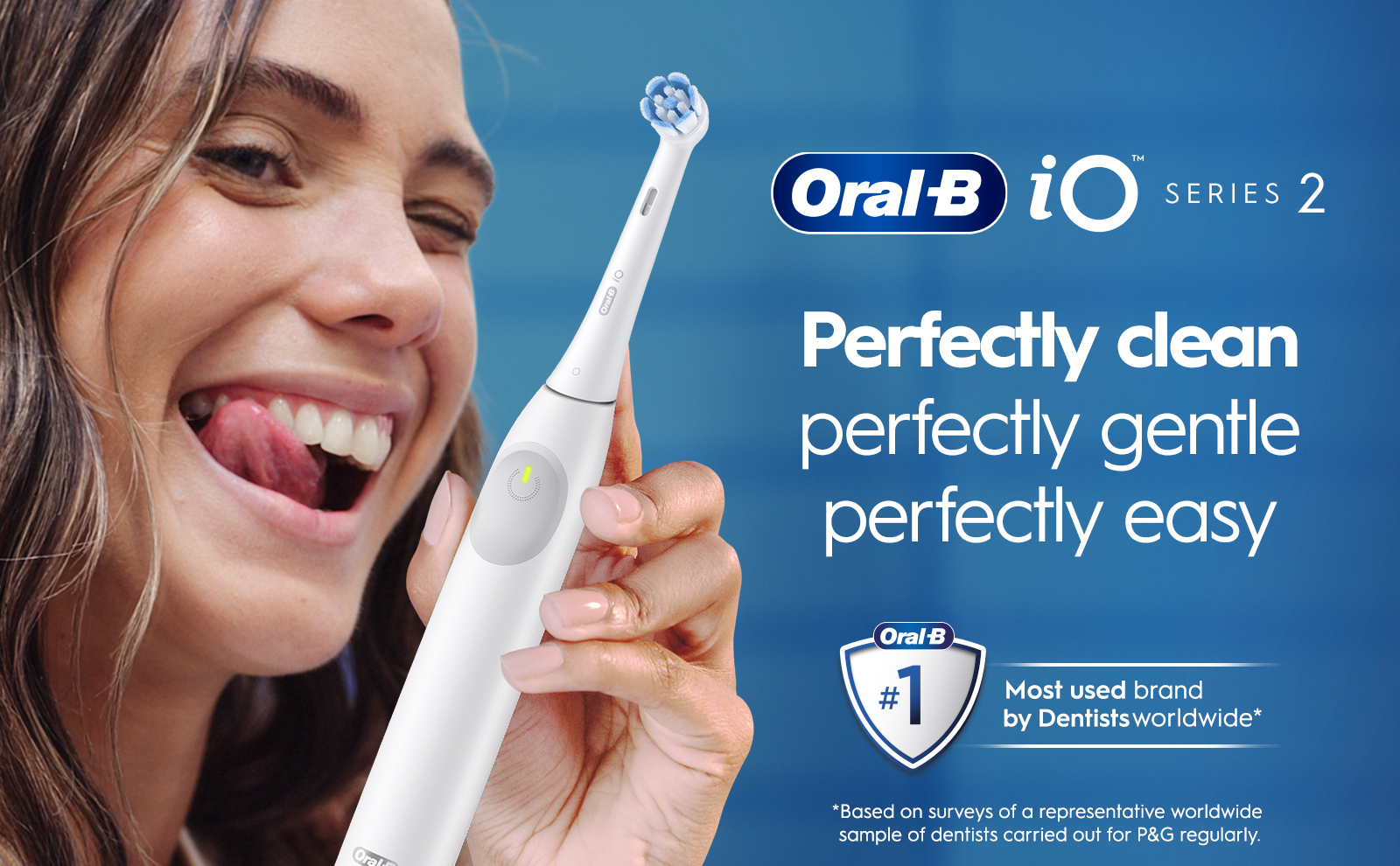 Image 1 - A smiling person with long hair is holding an electric toothbrush, sticking out their tongue playfully, with text beside them reading Oral-B iO Series 2, and the phrases Perfectly clean perfectly gentle perfectly easy, along with a badge stating #1 Most used brand by Dentists worldwide.