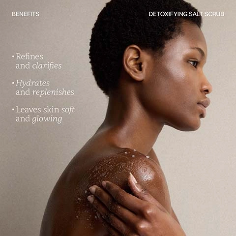 Image 2 - A person with short dark hair and bare shoulders applies a salt scrub to their left shoulder, with text reading BENEFITS Refines and clarifies Hydrates and replenishes Leaves skin soft and glowing and DETOXIFYING SALT SCRUB. Image 4 - An image of white, granular detoxifying salt scrub on a light background, accompanied by a small clear liquid blob, displaying a 5-star rating, a customer review that says This body scrub is absolutely amazing. Firstly it gently exfoliates your skin and secondly it smells incredible. - KAREN, and the text Reviews and Detoxifying Salt Scrub. Image 5 - A persons hand is shown covered in a white, granular salt scrub with an oily base, resting on a white towel, with text labels TEXTURE DETOXIFYING SALT SCRUB Naturally coarse sea salt crystals Nourishing layer of Sweet Almond Oil.