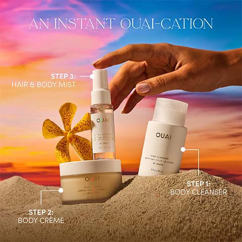 Image 1 - A hand reaches for an OUAI hair and body mist, part of a three-step routine with an OUAI body crème and OUAI body cleanser, all arranged on sand dunes against a vibrant sunset sky with a yellow flower, with visible text AN INSTANT OUAI-CATION, STEP 1: BODY CLEANSER, STEP 2: BODY CRÈME, STEP 3: HAIR & BODY MIST, OUAI ST. BARTS 3fl oz / 90 ml, OUAI BODY CREME ST. BARTS, and OUAI BODY CLEANSER NETTOYANT POUR LE CORPS ST. BARTS 3fl oz / 90 ml. Image 2 - A woman in a golden bikini sprays mist on her face with her eyes closed against an orange and blue gradient background, with the text SMELLS LIKE... YOURE OUT OF OFFICE EVERY HOUR IS HAPPY HOUR YOUR ROOM HAS AN OCEAN VIEW. Image 3 - A halved dragon fruit, a halved orange, and white blossoms are displayed on a peachy-orange background, with the text OUAI ST. BARTS and NOTES OF: DRAGON FRUIT | ORANGE BLOSSOM | TUBEROSE | MUSK.