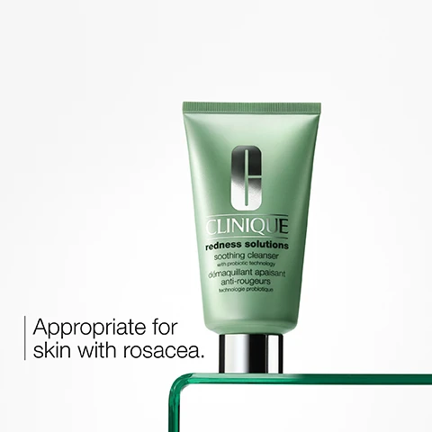 Image 1 - Image of a green tube of Clinique Redness Solutions Soothing Cleanser with the text appropriate for skin with rosacea.
              Image 2 - A green jar of Cliniques redness solutions cream is perched on a silver holder, with visible text stating Appropriate for skin with rosacea.