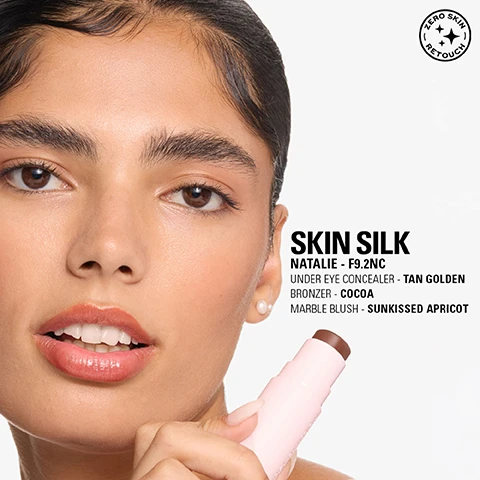 Image 1 - A close-up of a womans face with natural-looking makeup and a pearl earring, holding a pink makeup stick with a brown tip, includes text reading ZERO SKIN RETOUCH, SKIN SILK, NATALIE - F9.2NC, UNDER EYE CONCEALER - TAN GOLDEN, BRONZER - COCOA, MARBLE BLUSH - SUNKISSED APRICOT. Image 2 - A smiling woman with visible freckles holds a coral-pink and yellow swirled makeup stick to her cheek, with text that reads SKIN SILK EMILY - F7NC UNDER EYE CONCEALER - DEEP RED BRONZER - SUNKISSED MARBLE BLUSH - SUNKISSED APRICOT and a circular seal at the bottom right that says ZERO SKIN RETOUCH. Image 3 - A close-up portrait of a woman with blonde hair, blue eyes, fair skin, rosy cheeks, and matte peachy-pink puckered lips, with text on the left reading SKIN SILK, IRINA - F6.5N, UNDER EYE CONCEALER - FAIR COOL, BRONZER - SUNSET, MARBLE BLUSH - PEACHY PINK, and a circular logo in the top right stating ZERO SKIN RETOUCH.