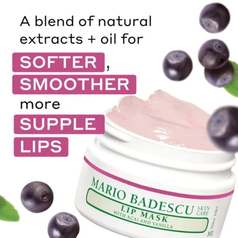 An open jar of pink lip mask is surrounded by dark berries and a green leaf, with text that reads A blend of natural extracts + oil for SOFTER, SMOOTHER more SUPPLE LIPS, and on the jar, MARIO BADESCU LIP MASK WITH ACAI AND VANILLA SKIN CARE Since 1967 MB.