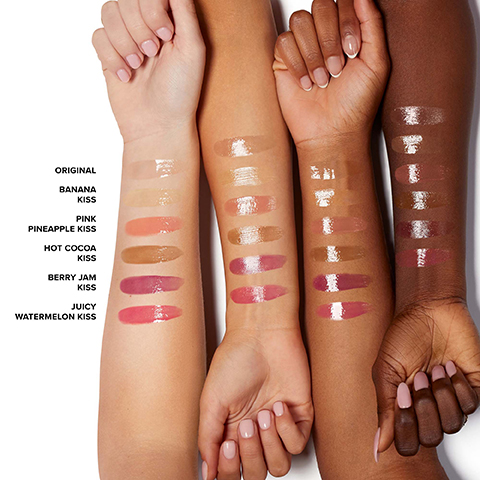 Three arms with various shades of lip swatches are displayed, with visible labels reading ORIGINAL, BANANA KISS, PINK, PINEAPPLE KISS, HOT COCOA KISS, BERRY JAM KISS, and JUICY WATERMELON KISS on the left side.