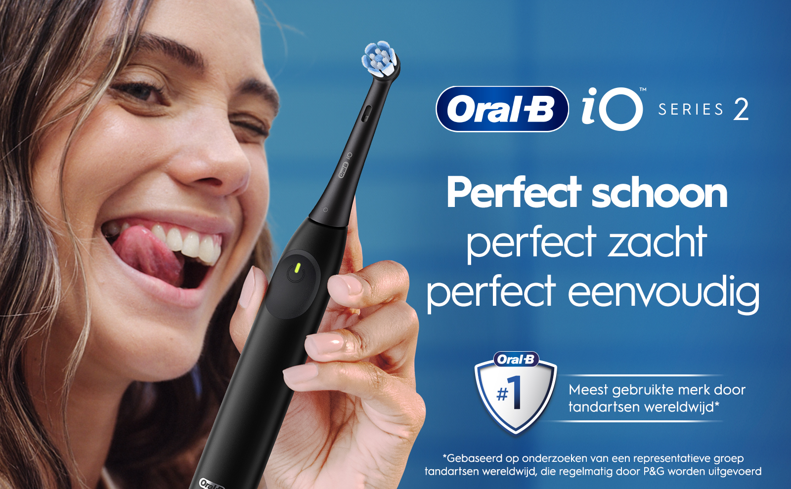 A woman smiles and playfully sticks out her tongue while holding an electric toothbrush, with text that reads Oral-B, Perfect schoon perfect zacht perfect eenvoudig, and a badge stating Oral-B #1 Meest gebruikte merk door tandartsen wereldwijd.