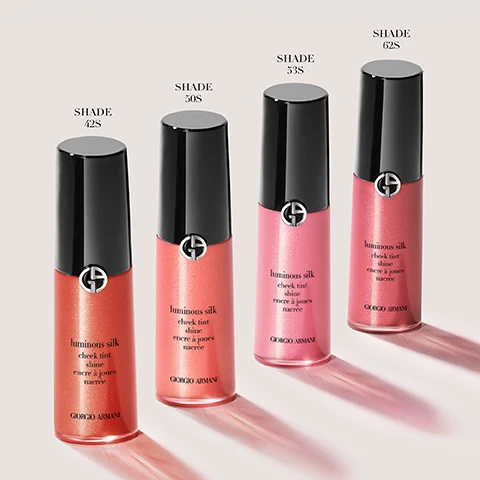 Image 1 - Four bottles of Giorgio Armani Luminous Silk Cheek Tint are displayed in shades 42S, 50S, 53S, and 62S, with corresponding labels above each bottle.
              Image 2 - A close-up of a woman with fair skin and blonde hair holding a tube of liquid blush near her face, showcasing a natural makeup look, with text reading UP TO 12H SKIN-FUSING PEARLY LIQUID BLUSH and a note about a consumer test of 84 women.
              Image 3 - Three close-up portraits of a woman showcasing different makeup looks with labels above each photo: Lifted Cheek Effect, Boyfriend Blush, and Monochromatic Look, along with application instructions below each image stating: Apply two dots on high cheekbones, blend towards temples, Dab blush on apples of cheeks, blend slightly outwards, stay low, Apply two dots on cheeks, one on brow bone and a touch more to lips. Blend with brush.
              Image 4 - Three Giorgio Armani makeup products are displayed: a bottle labeled FOUNDATION with text stating Perfect, glowy skin in a bottle, a bottle labeled CONCEALER with text stating Lightweight, buildable formula, and a bottle labeled CHEEK TINT SHINE with text stating Longwear pearly liquid, effortless blend.