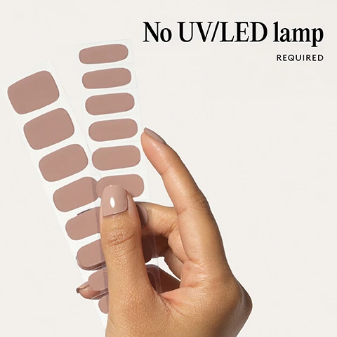 Image 1 - A hand holding two sheets of tan nail polish strips with text No UV/LED lamp REQUIRED. Image 2 - Two glossy brown nail shapes on a light background with the text 100% real salon-quality gel. Image 3 - A hand with pale beige nails is near glossy lips with icons and text for Cruelty-free, Vegan, HEMA-free. Image 4 - Close-up of a persons mouth with glossy lips and a hand with neutral nail polish touching the lips, with the text Lasts up to 14 days. Image 5 - A hand with light brown fingernails is shown with the text 1 minute removal NO DAMAGE. Image 6 - Close up of a hand with neutral shiny nails near a mouth Long-lasting shine AND CHIP-RESISTANT Image 7 - Illustration of four steps for applying nail wraps with corresponding instructions Step by step 01 PREP 02 STICK & WRAP 03 TRIM & FILE 04 REMOVE. Image 8 - Image shows a list of features above three pre-cut red nail polish strips, one with white stripes, with text reading Easiest and gentlest mani in the world Lasts up to 14 days Fast & gentle 1-min removal Fully-cured - No LED Lamp required Comes in 10 sizes Long-lasting shine and chip-resistant Quick and easy application Hema-free, vegan, and cruelty-free Pre-cut and ready to go!.