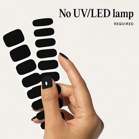 Image 1 - Hand holding two strips of black nail stickers with black polish and a white dot on the thumb, with text No UV/LED lamp REQUIRED. Image 2 - Two artificial nails, one large and one small, painted black with text below reading 100% real salon-quality gel. Image 3 - A close-up shows a mouth with red lipstick and a finger with black nail polish, alongside icons and text that say Cruelty-free, Vegan, HEMA-free. Image 4 - A hand with black painted fingernails is shown with the text 1 minute removal NO DAMAGE. Image 5 - A diagram showing four steps for applying nail wraps, with illustrations and text, titled Step by step, 01 PREP Use a Wooden Cuticle Stick to gently push back your cuticles and buff the shine off your nail plates with a 240 grit nail file. Cleanse each nail using a Lint Free Wipe soaked in Prep & Wipe to remove any oils, this helps the wraps adhere better and last longer. If you dont have these products, washing your hands is a good alternative. If your nails are naturally oily, apply Nail Dehydrator as an extra step after cleansing. 02 STICK & WRAP Choose your favourite design and select the right width wrap for each nail - if youre between sizes, go slightly smaller. Peel the wrap from the sheet, touching only the end that wont go on the nail. Apply the wrap as close to the cuticle as possible without touching the skin. Press the wrap firmly from the centre outwards to avoid air bubbles. Use your thumb to press down and seal the edges. 03 TRIM & FILE Trim any excess as close to your nail length as possible using Curved Edged Scissors. After trimming, press the wrap firmly over the free edge of the nail, then file in only one direction, from top to bottom, using a 180 grit nail file. Lightly file underneath the free edge to remove excess and align the edges. Finish by pressing down again to fully seal the wrap in place. Avoid applying any oils or getting your hands wet for at least 2 hours after application to ensure maximum adhesion. Then youre set for up to 14 days! 04 REMOVE Quick, damage-free removal in just 1 minute. Apply Mylee Wrap Remover Oil around the edges of the wrap. Gently lift one side with a Wooden Cuticle Stick and slowly slide it underneath, adding more oil as needed. Once removed, wipe your nails and wash your hands. Image 6 - A strip of three red nail polish wraps is shown next to a list of features: Easiest and gentlest mani in the world Lasts up to 14 days Fast & gentle 1-min removal Fully-cured - No LED Lamp required Comes in 10 sizes Long-lasting shine and chip-resistant Quick and easy application Hema-free, vegan, and cruelty-free Pre-cut and ready to go!