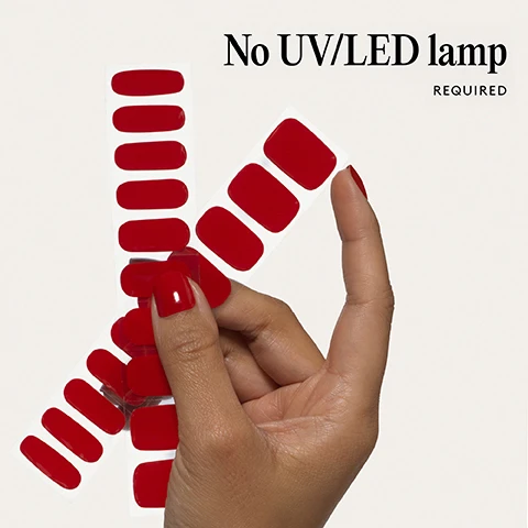 Image 1 - A hand holds sheets of red nail polish strips, with one finger wearing a strip, and the text reads No UV/LED lamp REQUIRED. Image 2 - Two red artificial nails, one larger and one smaller, are shown on a light background with the text 100% real salon-quality gel. Image 3 - A person with glossy red lips and red painted fingernails with the text Lasts up to 14 days. Image 4 - A hand with red painted fingernails and the text 1 minute removal NO DAMAGE. Image 5 - A four-step illustrated guide for applying and removing nail wraps Step by step 01 PREP Use a Wooden Cuticle Stick to gently push back your cuticles and buff the shine off your nail plates with a 240 grit nail file. Cleanse each nail using a Lint Free Wipe soaked in Prep & Wipe to remove any oils - this helps the wraps adhere better and last longer. If you dont have these products, washing your hands is a good alternative. If your nails are naturally oily, apply Nail Dehydrator as an extra step after cleansing. 02 STICK & WRAP Choose your favourite design and select the right width wrap for each nail - if youre between sizes, go slightly smaller. Peel the wrap from the sheet, touching only the end that wont go on the nail. Apply the wrap as close to the cuticle as possible without touching the skin. Press the wrap firmly from the centre outwards to avoid air bubbles. Use your thumb to press down and seal the edges. 03 TRIM & FILE Trim any excess as close to your nail length as possible using Curved Edged Scissors. After trimming, press the wrap firmly over the free edge of the nail, then file in only one direction, from top to bottom, using a 180 grit nail file. Lightly file underneath the free edge to remove excess and align the edges. Finish by pressing down again to fully seal the wrap in place. Avoid applying any oils or getting your hands wet for at least 2 hours after application to ensure maximum adhesion. Then youre set for up to 14 days! 04 REMOVE Quick, damage-free removal in just 1 minute. Apply Mylee Wrap Remover Oil around the edges of the wrap. Gently lift one side with a Wooden Cuticle Stick and slowly slide it underneath, adding more oil as needed. Once removed, wipe your nails and wash your hands. Image 6 - Easiest and gentlest mani in the world Lasts up to 14 days Fast & gentle 1-min removal Fully-cured - No LED Lamp required Comes in 10 sizes Long-lasting shine and chip-resistant Quick and easy application Hema-free, vegan, and cruelty-free Pre-cut and ready to go! with three red and white nail polish strips on a clear backing below the text.