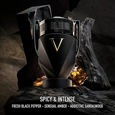 Image 1 - A black, trophy-shaped perfume bottle with a gold V on the front stands among dark wood and amber resin, with text below reading SPICY & INTENSE FRESH BLACK PEPPER – SENSUAL AMBER – ADDICTIVE SANDALWOOD. Image 2 - A visual comparison of five Invictus fragrances in trophy-shaped bottles, presented from left to right as: Invictus Eau de Toilette (Aromatic & Fresh), Invictus Parfum (Woody & Clean), Invictus Victory Parfum Intense (Amber & Extreme), Invictus Victory Elixir Parfum Intense (Amber & Addictive), and Invictus Victory Absolu Parfum Intense (Spicy & Intense), with a scale at the bottom ranging from + FRESH to + INTENSE. Image 3 - A black and white image features a muscular man wearing layered necklaces, standing in front of shelves filled with trophies, with a large trophy cup on his left and a black and gold trophy-shaped fragrance bottle on his right, bearing the text INVICTUS VICTORY ABSOLU V.
