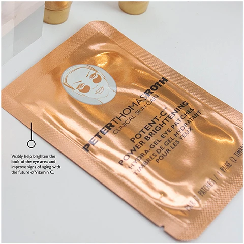 Image 1 - Image of a copper-colored skincare mask packet featuring a womans illustration and text stating PETER THOMAS ROTH CLINICAL SKINCARE POTENT-C POWER BRIGHTENING EYE GEL PATCHES with a note that says visibly help brighten the look of the eye area and improve signs of aging with the future of Vitamin C.
              Image 2 - Two tubes of gold-colored skincare treatment are displayed on a clear acrylic stand, with the label reading Infused with 24K Gold and Colloidal Gold, this ultimate luxurious anti-aging treatment.
              Image 3 - A tube of Peter Thomas Roth Potent-C Brightening Vitamin C moisturizer, standing on a clear acrylic block, with accompanying text describing its benefits and ingredients.