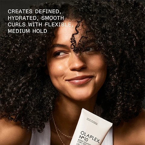 Image 1 - A smiling woman with curly hair holds an Olaplex hair product in her hand, and the image includes the text CREATES DEFINED, HYDRATED, SMOOTH CURLS WITH FLEXIBLE, MEDIUM HOLD.
              Image 2 - A tube of Olaplex No. 10 Bond Smoother Curl Defining Gel is shown, with visible text stating 3X GREATER CURL RETENTION and stating that results are clinically proven.
              Image 3 - Image shows a comparison of curly hair before and after using specific hair products, with the left side labeled BEFORE displaying frizz and the right side labeled AFTER showing defined curls, accompanied by a note about results varying based on product use.
              Image 4 - Side-by-side comparison of hair before and after using OLAPLEX products, showing smoother curls on the right labeled as AFTER and frizzier hair on the left labeled as BEFORE; visible text includes UNRETOUCHED IMAGES and results disclaimer.
              Image 5 - A comparison image showing the back of a persons head with curly hair, labeled BEFORE on the left and AFTER on the right, with visible text at the bottom describing the results and products used including OLAPLEX N°4 Bond Maintenance Shampoo and N°5 Bond Maintenance Conditioner.
              Image 6 - Image shows two hair care products from Olaplex: a tube of No. 10 Bond Smoothing Gel and a bottle of No. 5 Leave-In Conditioner, with text indicating their benefits for defining curls and moisturizing.