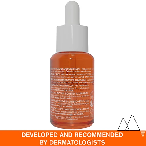 Image 1 - A brown glass dropper bottle containing a brightening serum with text in multiple languages on the label, and a bold orange banner at the bottom that reads DEVELOPED AND RECOMMENDED BY DERMATOLOGISTS.
              Image 2 - A close-up of a persons cheek with a drop of serum being applied, featuring text labels that read lightweight serum, non-greasy & non-sticky, and dark spots - dull complexion even sensitive.
              Image 3 - A young woman smiles while holding a bottle of Uriage Dépiderm serum, which is labeled with text about reducing dark spots in 28 days and its radiance-boosting effect.
              Image 4 - An infographic detailing an advanced dermatological formula includes sections labeled Mela Technology with a description about dark spot correction, 20% Vitamin C Complex emphasizing high tolerance for sensitive skin, and Niacinamide highlighting its soothing properties, all set against a light blue background.
              Image 5 - A scenic image of snow-capped mountains reflecting in a lake with text overlay indicating the product is recommended by dermatologists, suitable for sensitive skin, non-comedogenic, fragrance-free, and composed of 94% ingredients of natural origin.
              Image 6 - A bottle of Uriage Dépiderm anti-dark spot serum with a dropper, featuring a blue circular badge stating Developed by Dermatologists, alongside text in French and English indicating its purpose as a brightening booster for dark spots and dull complexion.